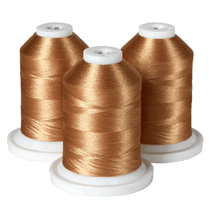 Three spools of gold embroidery thread on white bases for Brother sewing machines