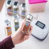 Brother label maker with organized spice jars featuring custom printed labels in kitchen
