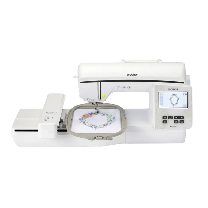 Brother NQ1700E embroidery machine with touchscreen displaying floral wreath design in hoop