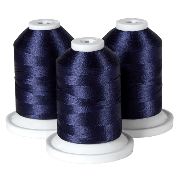 Three spools of navy blue embroidery thread on white bases