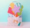Brother ScanNCut colorful fabric balloon card with decorative patterns on pink surface