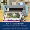Brother ScanNCut machine with built-in scanner cutting colorful floral design on adhesive mat