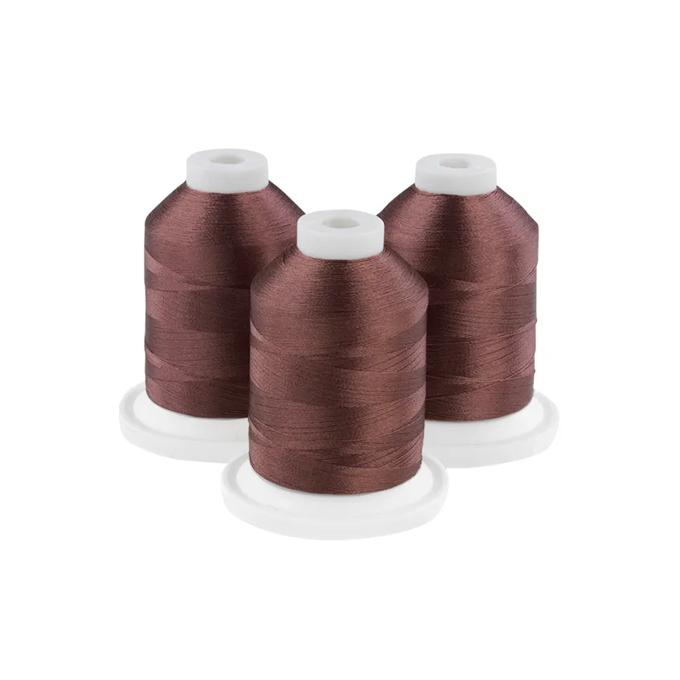 Three coffee bean brown embroidery thread spools on white bases
