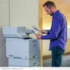 Man using Brother MFC-L9630CDN color laser all-in-one printer in office setting