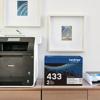 Brother all-in-one printer with TN433 2-pack toner cartridge box on home office desk