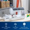Brother sewing and embroidery machine with touchscreen and built-in designs on workspace