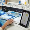 Brother sewing and embroidery machine with touchscreen displaying floral design pattern