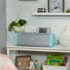 Brother electronic cutting machine with wireless touchscreen on white shelf in craft room