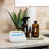 Brother label maker on kitchen counter with cleaning supplies and plant