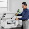 Man using Brother MFC-J6975DW all-in-one printer with open scan glass in modern office