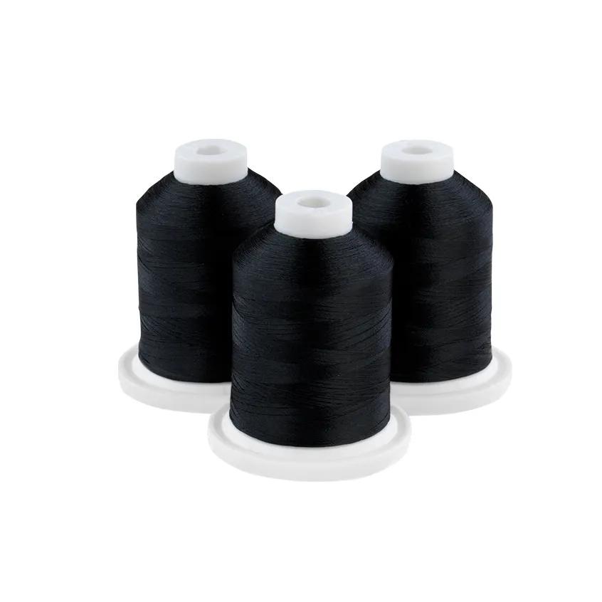 Three spools of midnight teal embroidery thread on white bases
