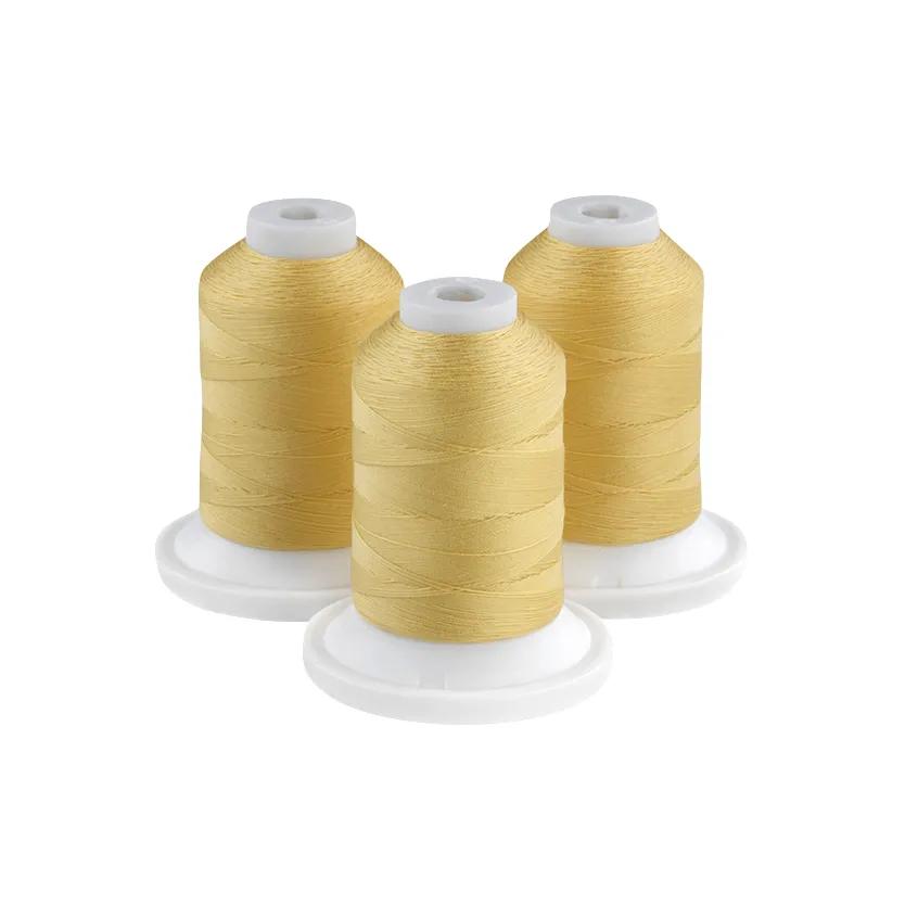 Three lemon yellow embroidery thread spools on white bases