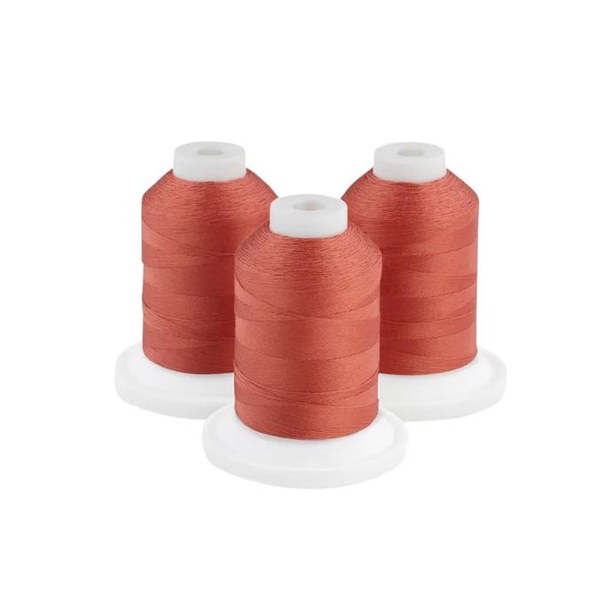Three dark rust embroidery thread spools on white bases