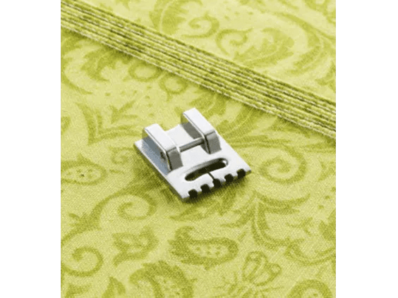 Brother sewing machine pintuck foot on yellow decorative fabric with stitched detail