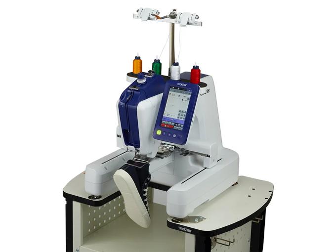 Brother embroidery machine with touchscreen and multi-color thread spools on stand