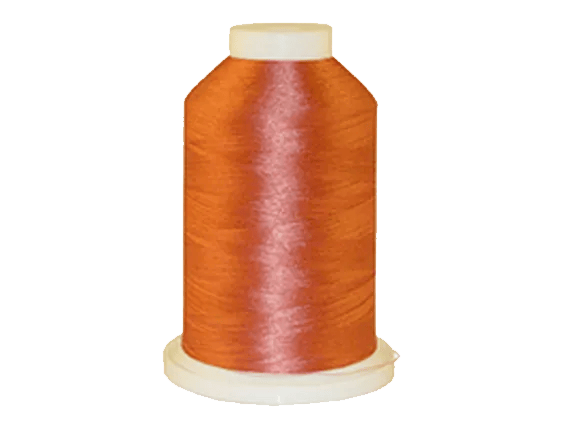 Brother orange embroidery thread spool on white background