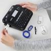 Brother P-touch handheld label maker with QWERTY keyboard printing laminated labels