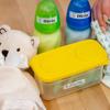 Brother P-touch label on storage bin with stuffed bear and bottles