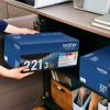 Person storing Brother TN-221 3-pack toner cartridges in home office cabinet