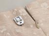 Brother sewing machine presser foot and seam ripper on beige fabric with leaf pattern