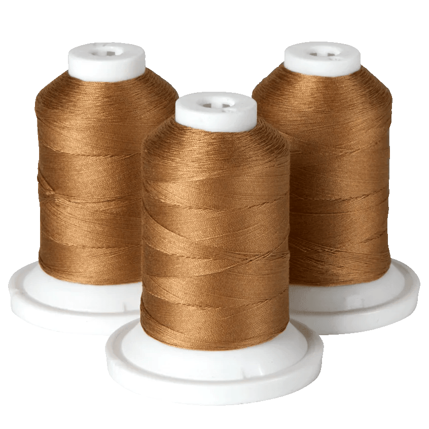 Three spools of gold embroidery thread on white cones for Brother sewing machines