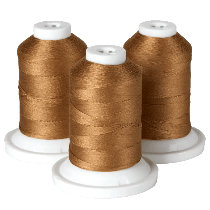 Three spools of gold embroidery thread on white cones for Brother sewing machines