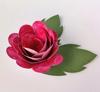 Pink paper rose craft with green leaves on white background