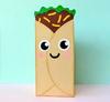 Paper lunch bag craft with smiling face, lettuce, and toppings on light blue background