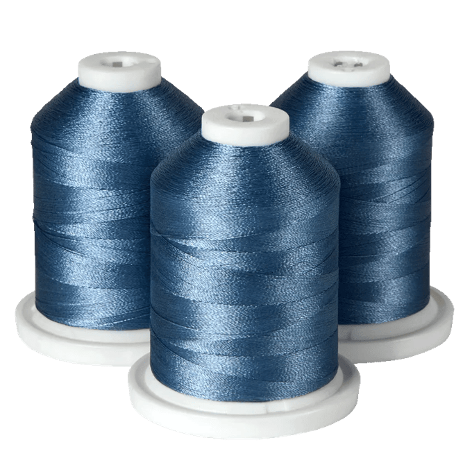 Three spools of blue embroidery thread on white bases for Brother sewing machines