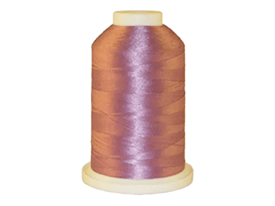 Brother embroidery thread spool in mauve purple on white background