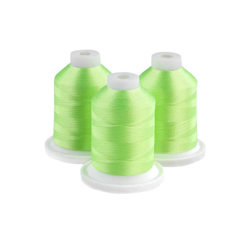 Three neon lime embroidery thread spools on white bases