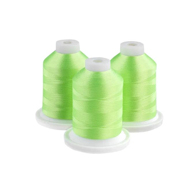 Three neon lime embroidery thread spools on white bases