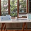 Brother Stellaire XJ2 embroidery machine with wireless connectivity on crafting table near window