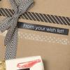 Brother TZe label tape decorating wrapped gift with black and white striped ribbon