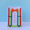 Colorful paper craft card with rainbow suspenders, orange bow tie, and white shirt design