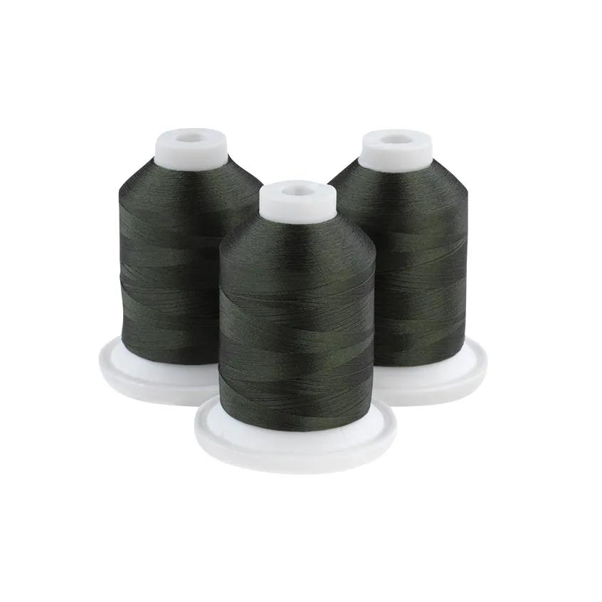 Three spools of olive drab embroidery thread on white bases