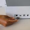 Hand inserting USB drive into Brother ADS-4900W wireless document scanner connectivity ports