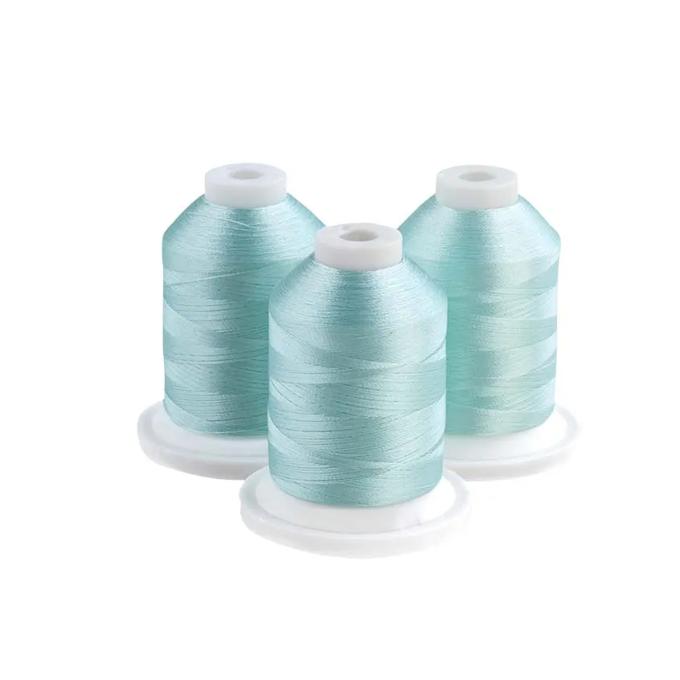 Three light blue embroidery thread spools on white bases