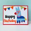 Colorful paper-cut birthday card with piñata llama and festive bunting banner