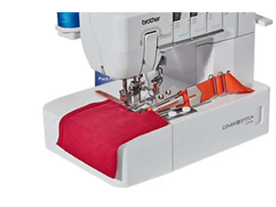 Brother cover stitch machine sewing red and orange fabric with precision stitching