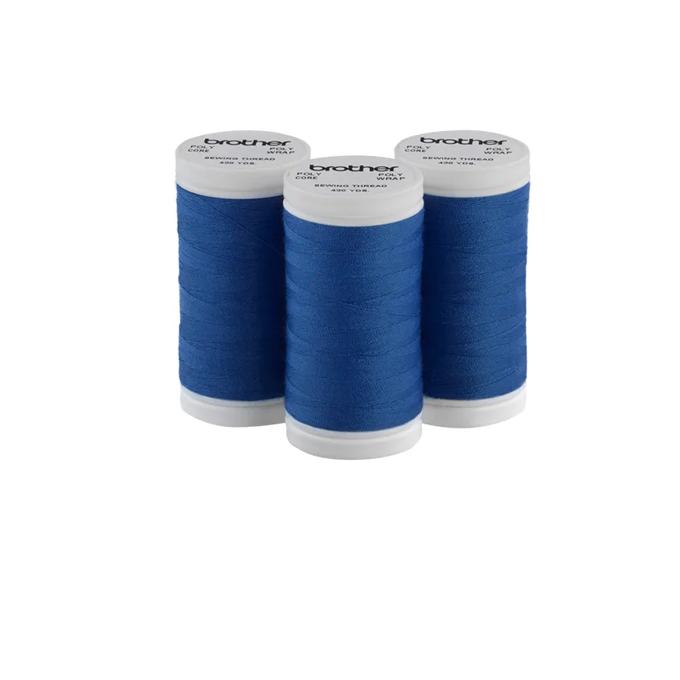 Three Brother blue sewing thread spools on white background