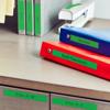 Brother wireless label maker organizing office files on desk with color-coded binders