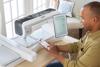 Man using Brother Luminaire Innov-ís XP3 sewing and embroidery machine with touchscreen display