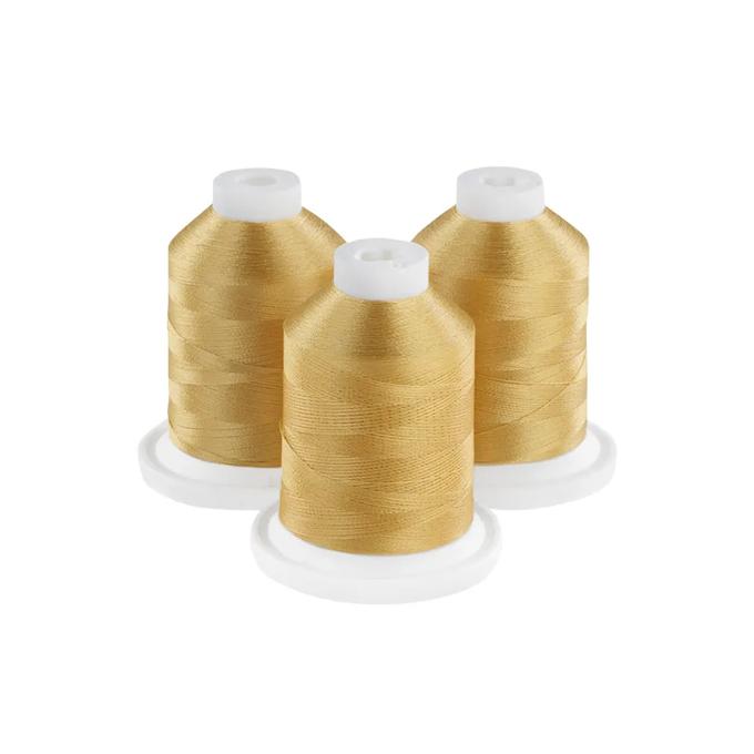 Three golden embroidery thread spools on white bases