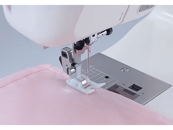 Brother sewing machine needle and presser foot stitching pink fabric with precision