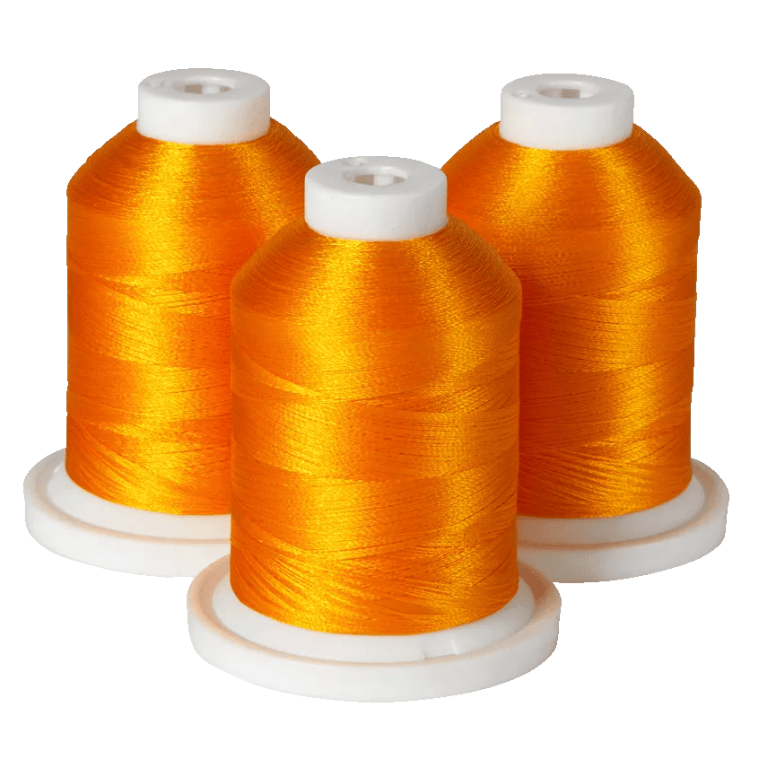 Three spools of vibrant orange embroidery thread on white bases