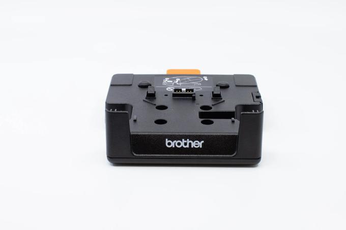 Brother BMS-432 battery eliminator with orange tab and mounting slots, front view
