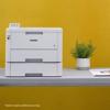 Brother HL-L8245CDW color laser printer with optional paper tray on gray surface