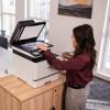 Woman scanning documents on Brother MFC-L8730CDW color laser all-in-one printer in home office