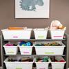White storage bins with colorful labels organizing toys on gray shelves in home